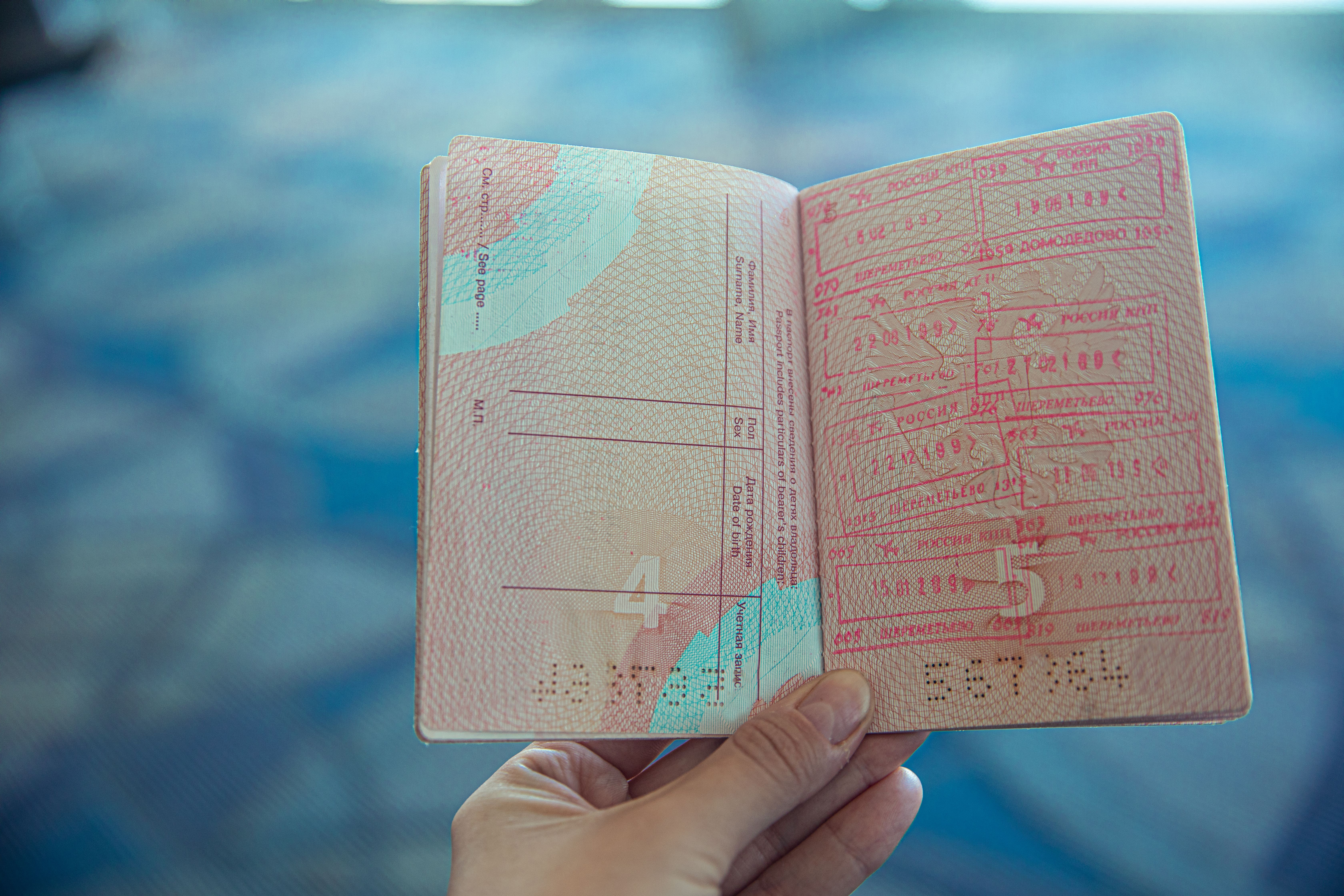 Open passport displaying travel stamps, illustrating cross-border legal jurisdiction