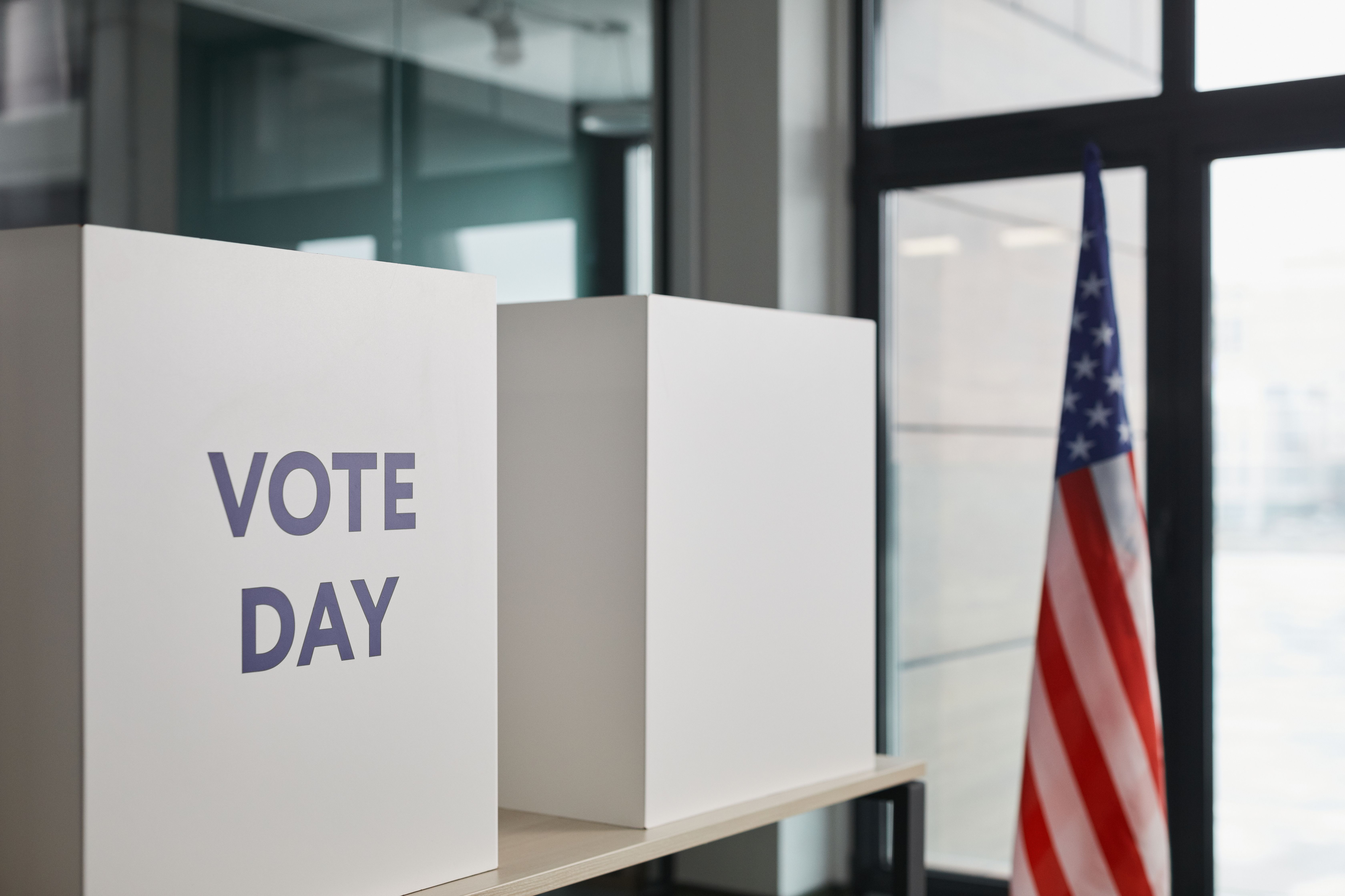 Voting booth setup with an American flag, symbolizing election day