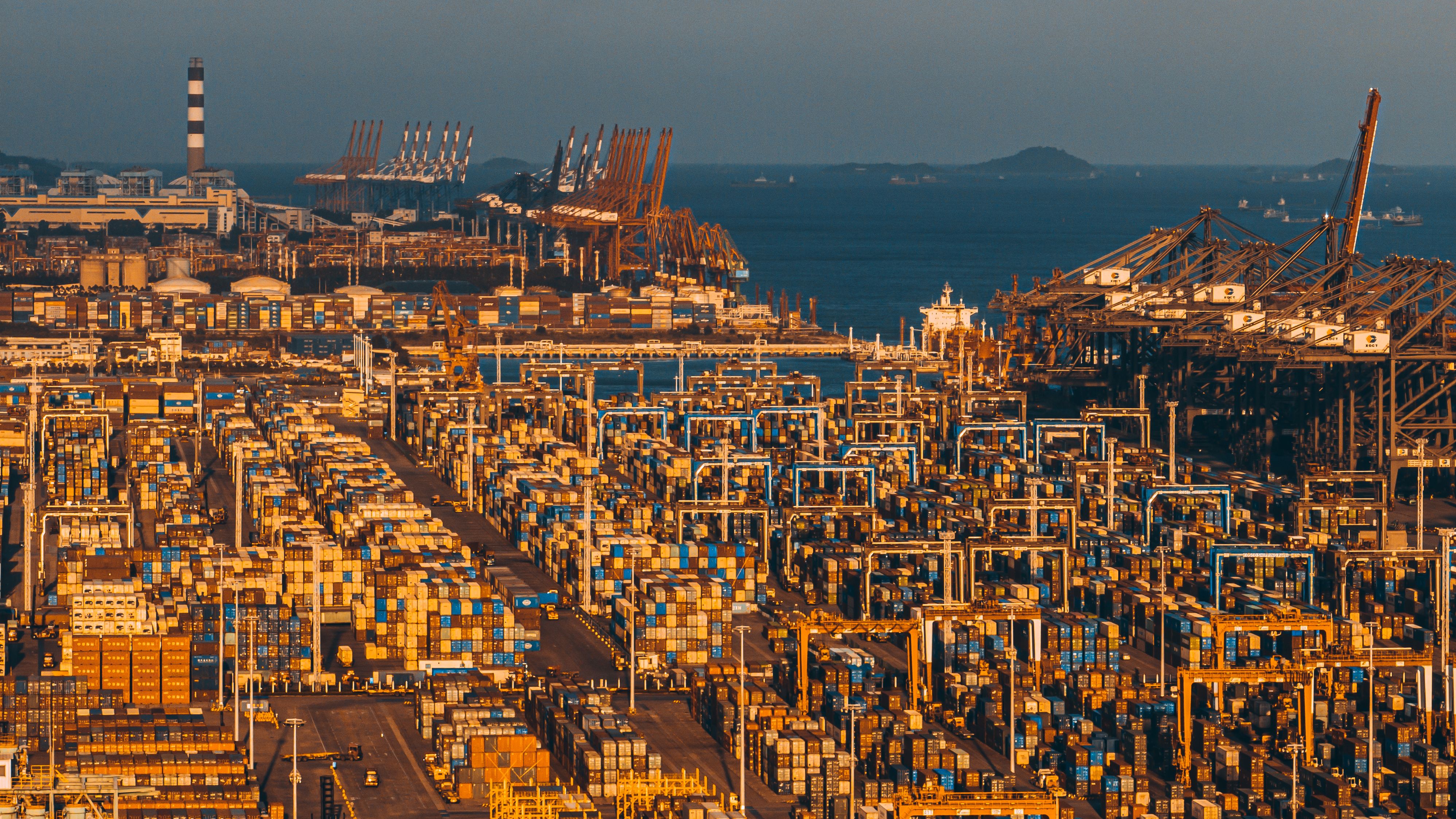 Aerial view of Xiamen port with stacked shipping containers and cranes